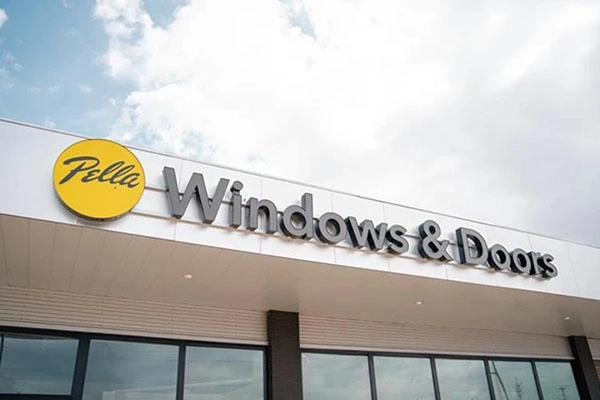 Exterior view of a Pella Windows & Doors store with the company logo and name displayed on the building facade.